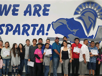 A group of students in front of a We Are Sparta! sign