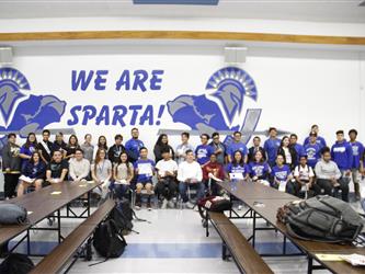 A group of students in front of a We Are Sparta! sign